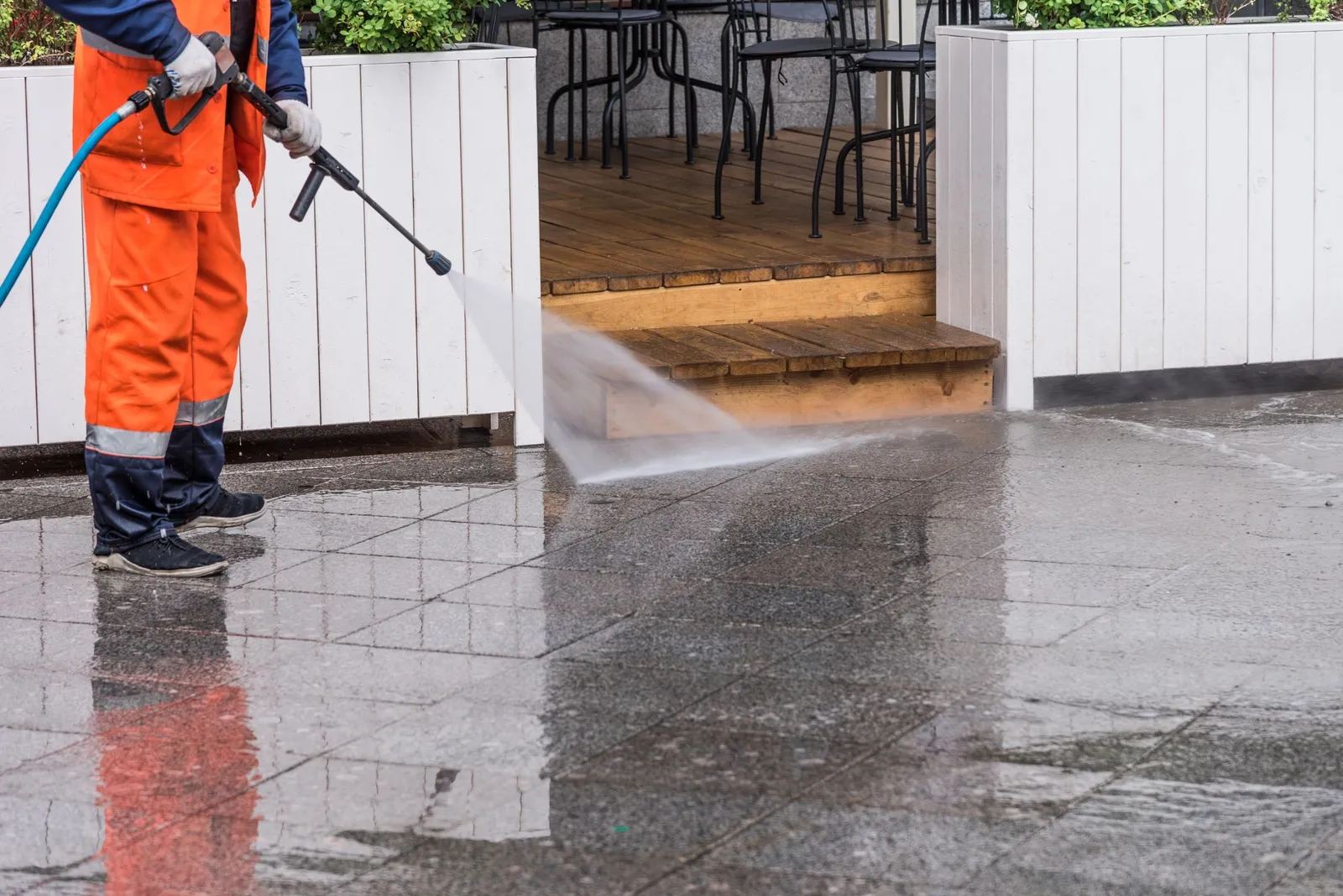 Pressure washing the siding of a Pacific Northwest home before repainting